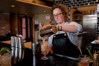 A bartender pouring drinks at backwards Distilling