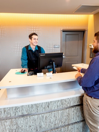 Man at Hotel Reception Desk